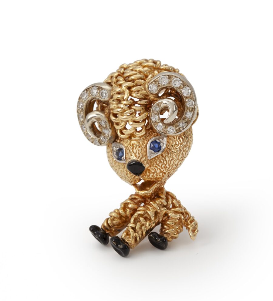 An eighteen carat yellow gold brooch designed as a ram, set with diamonds, sapphires and with black enamel. Signed Van Cleef & Arpels, Paris and dated 1963.