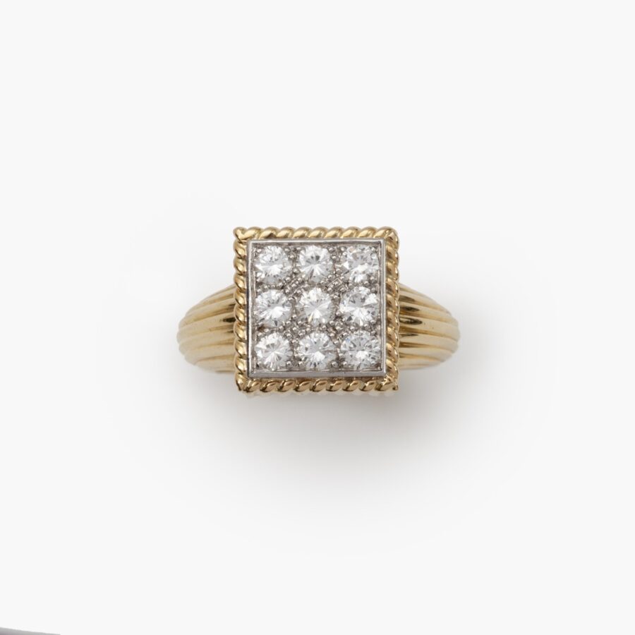 An eighteen carat yellow gold and platinum ring pavé set with brilliant cut diamonds. Signed Cartier Paris and numbered, made ca 1970.