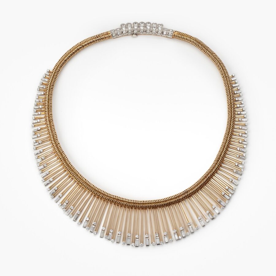 An eighteen carat yellow gold and platinum Retro necklace designed as a chain supporting a fringe set with diamonds. Signed Sterlé Paris. Made circa 1950.