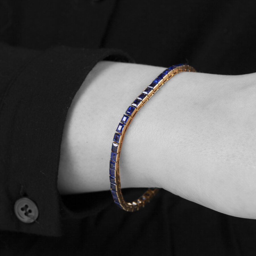 An eighteen carat rosé gold line bracelet set with baguette cut blue sapphires. Made by Cartier in Paris in 1918 and numbered. With IAJA Expertise report.