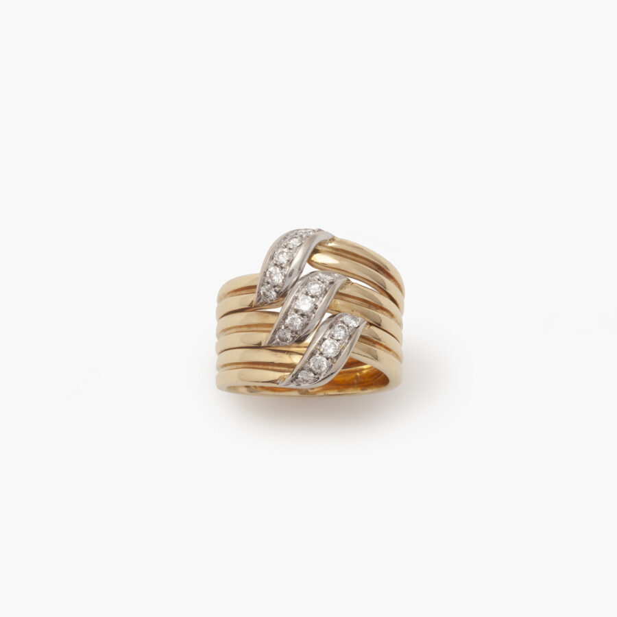 An eighteen carat yellow- and whitegold wide band ring, pavé set with brilliant cut diamonds. Signed Cartier and numbered, made in Italy. 