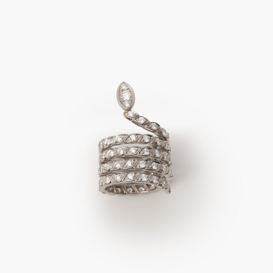 A platinum ring designed as a snake set with brilliant cut diamonds. Signed Sterlé and numbered, made in Paris, ca 1960. 