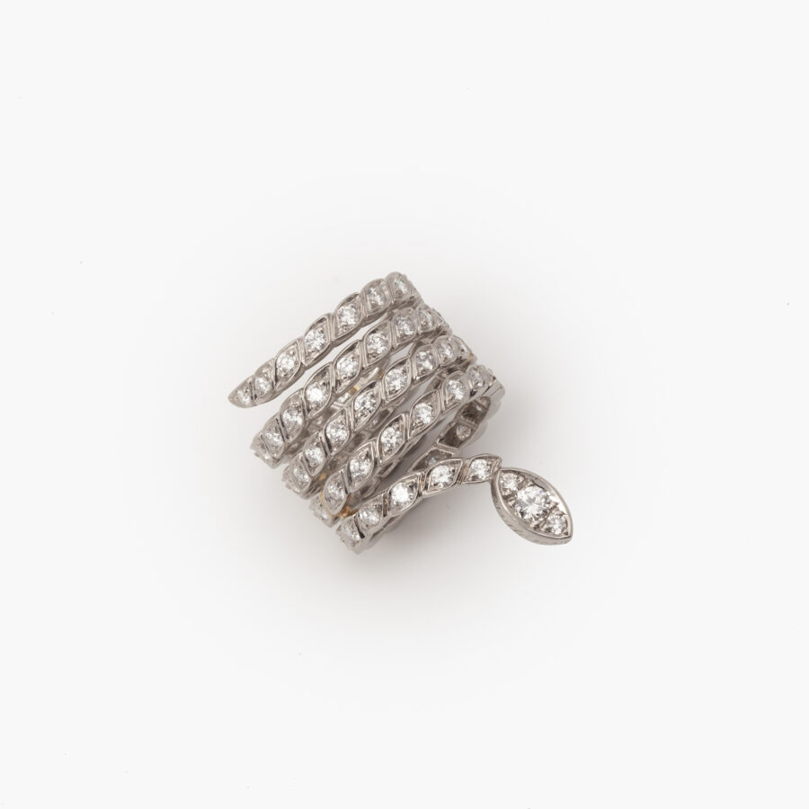 A platinum ring designed as a snake set with brilliant cut diamonds. Signed Sterlé and numbered, made in Paris, ca 1960. 