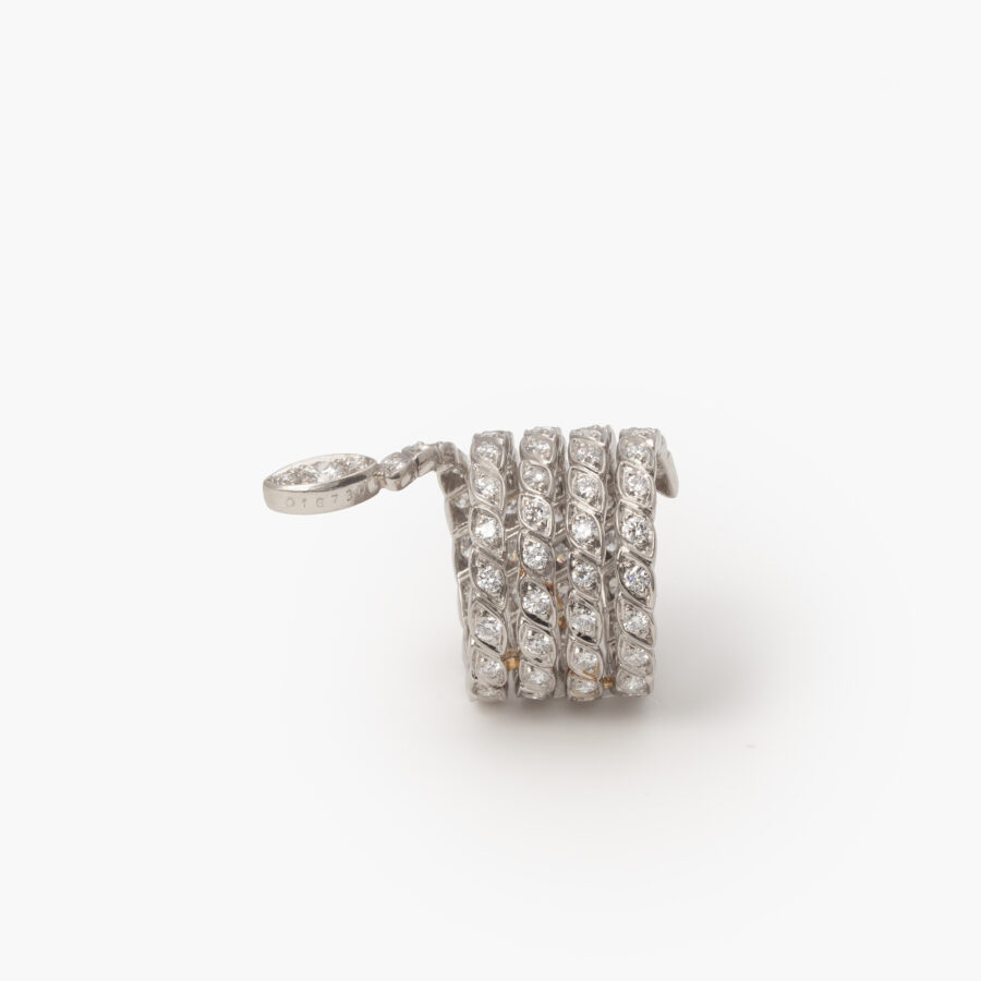 A platinum ring designed as a snake set with brilliant cut diamonds. Signed Sterlé and numbered, made in Paris, ca 1960. 