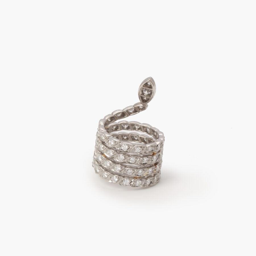 A platinum ring designed as a snake set with brilliant cut diamonds. Signed Sterlé and numbered, made in Paris, ca 1960. 