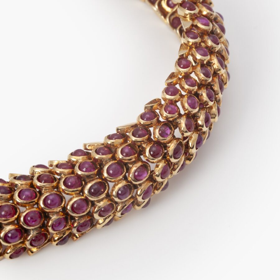 An eighteen carat yellow gold bracelet “Écailles”, set cabochon cut rubies. By René Boivin, design by Juliette Moutard, Paris ca 1955. With certificates.