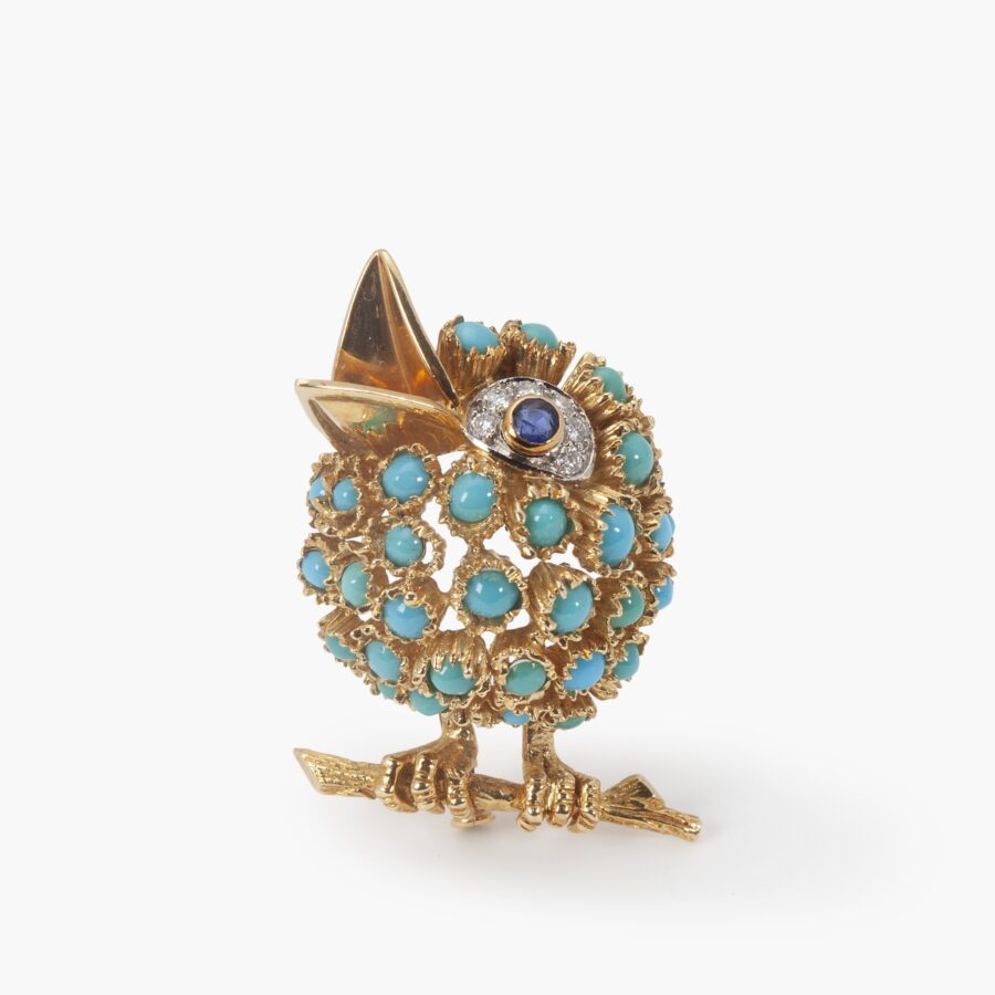 An eighteen carat yellow gold bird brooch set with turquoise, blue sapphire and diamonds. Signed Van Cleef & Arpels, Paris. Numbered and dated 1964. 