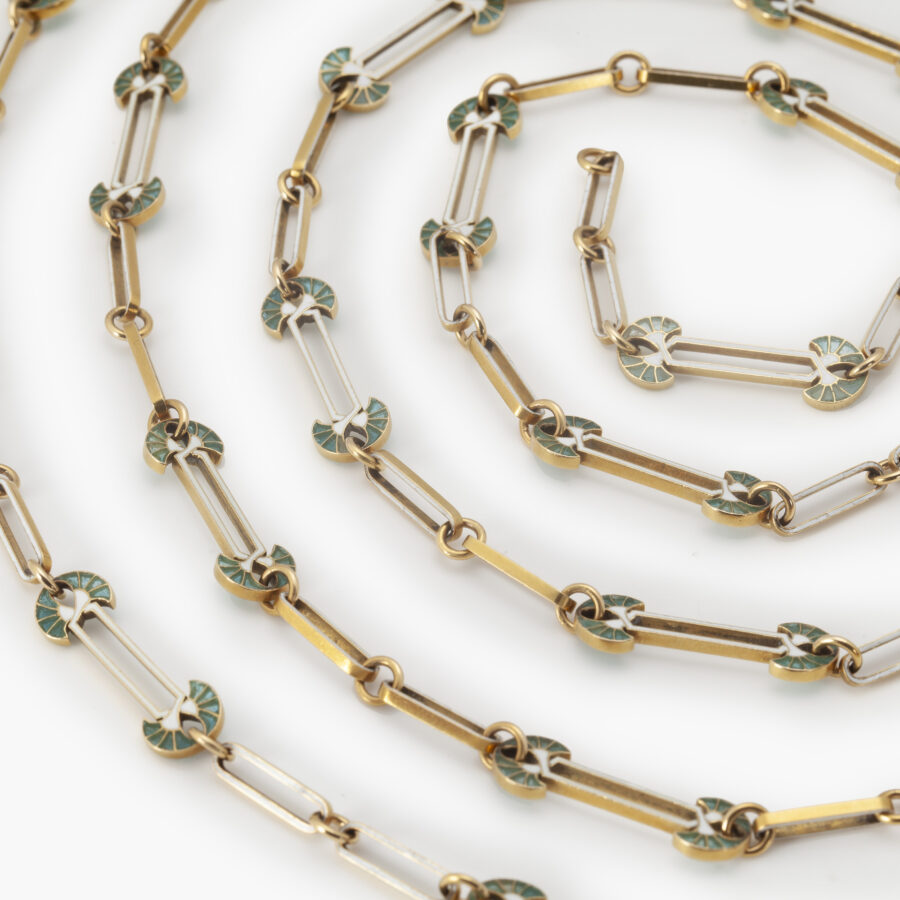 An eighteen carat yellow gold Art Nouveau longchain decorated with white and bluish-green enamel. Signed Lalique, made in France, ca 1900.