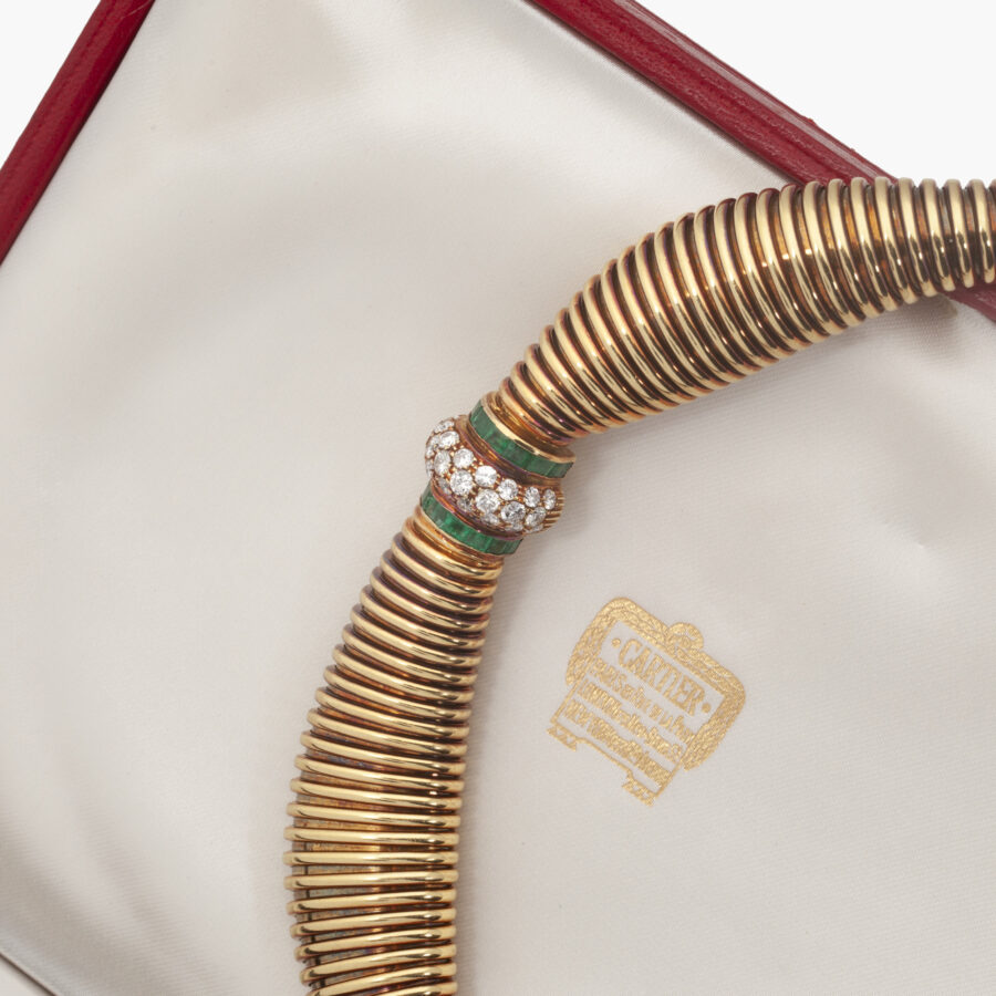 An eighteen carat yellow gold necklace, set with diamonds and emeralds. Signed Cartier and numbered. Made in Italy, ca 1965. With IAJA certificate.