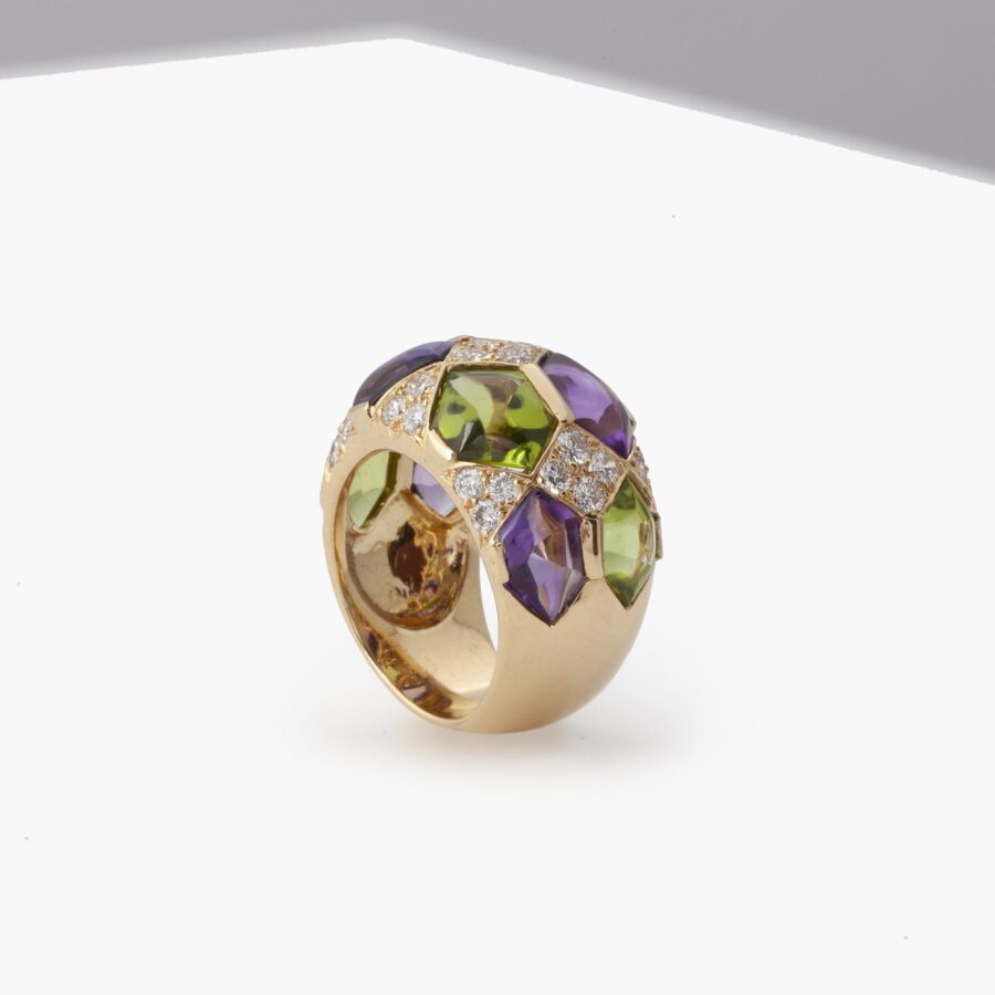 A pair of eighteen carat yellow gold clip earrings with matching ring, set with diamonds, amethysts and peridots. Van Cleef & Arpels, Paris, ca 1990. 