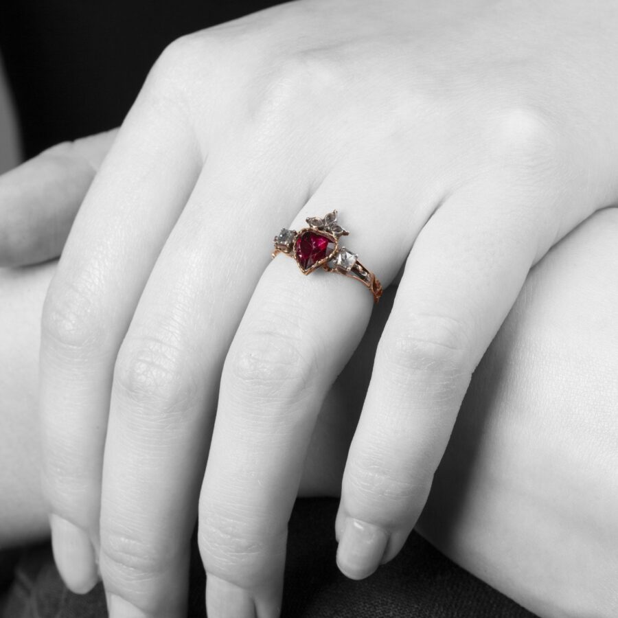 An eighteen carat yellow gold and silver ring designed as a crowned heart, set with a topaz and diamonds. Made 1st half of the 19th century, in antique box.