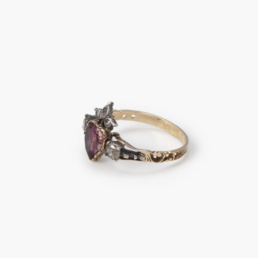 An eighteen carat yellow gold and silver ring designed as a crowned heart, set with a topaz and diamonds. Made 1st half of the 19th century, in antique box.