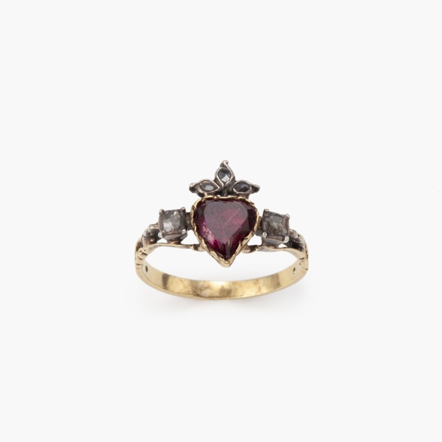 An eighteen carat yellow gold and silver ring designed as a crowned heart, set with a topaz and diamonds. Made 1st half of the 19th century, in antique box.