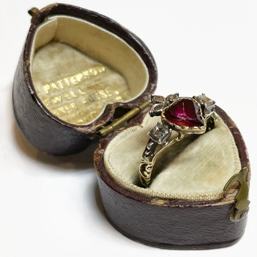 An eighteen carat yellow gold and silver ring designed as a crowned heart, set with a topaz and diamonds. Made 1st half of the 19th century, in antique box.