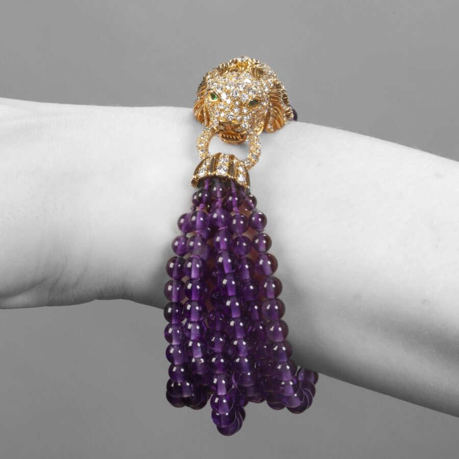 A yellow gold bracelet ‘Lion Barquerolles’ designed as a lion’s head clasp on amethyst beads. Signed Van Cleef & Arpels, New York. Numbered and dated 1971.