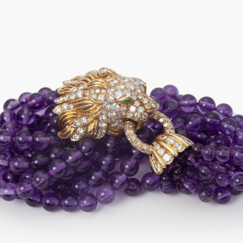 A yellow gold bracelet ‘Lion Barquerolles’ designed as a lion’s head clasp on amethyst beads. Signed Van Cleef & Arpels, New York. Numbered and dated 1971.