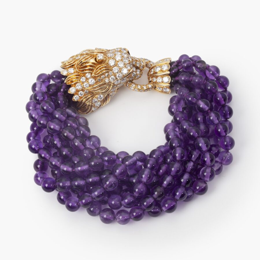 A yellow gold bracelet ‘Lion Barquerolles’ designed as a lion’s head clasp on amethyst beads. Signed Van Cleef & Arpels, New York. Numbered and dated 1971.