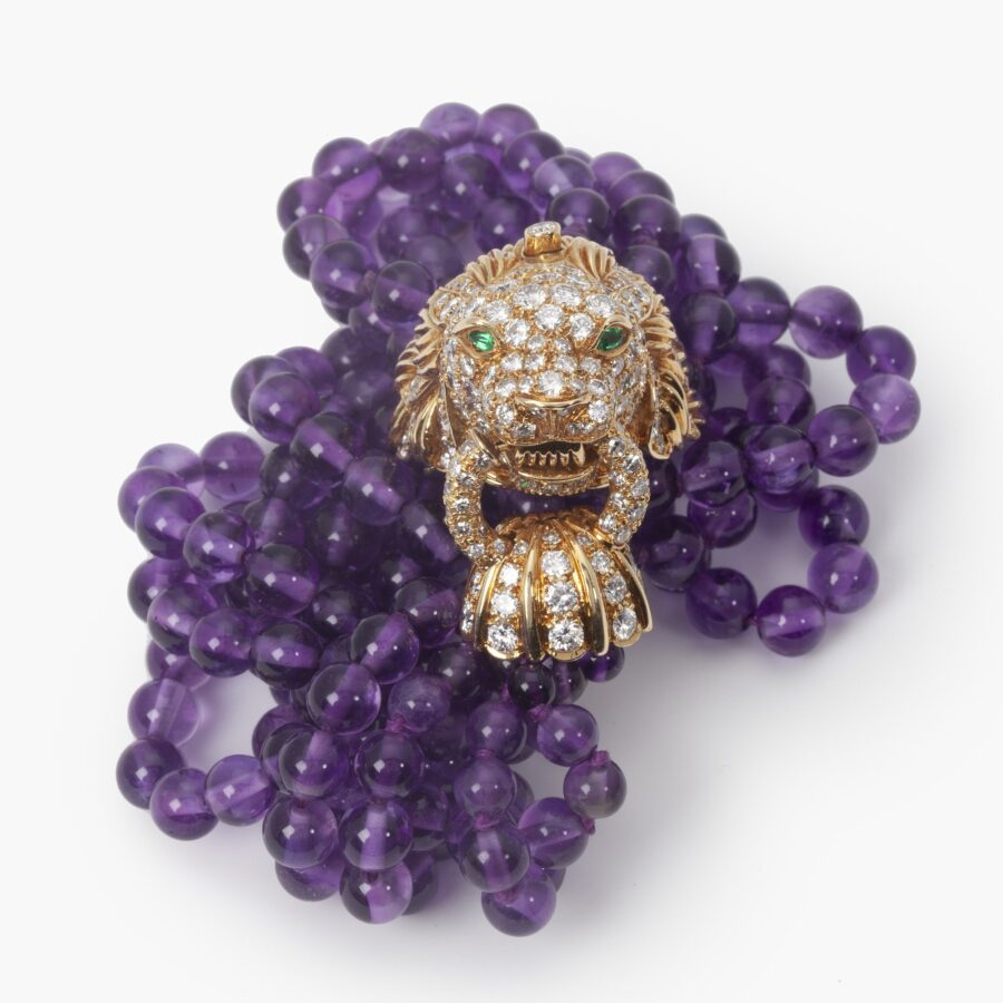 A yellow gold bracelet ‘Lion Barquerolles’ designed as a lion’s head clasp on amethyst beads. Signed Van Cleef & Arpels, New York. Numbered and dated 1971.