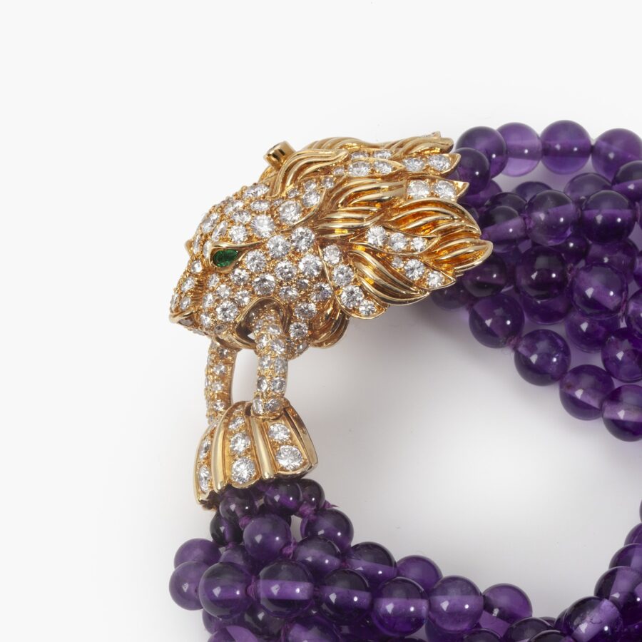 A yellow gold bracelet ‘Lion Barquerolles’ designed as a lion’s head clasp on amethyst beads. Signed Van Cleef & Arpels, New York. Numbered and dated 1971.