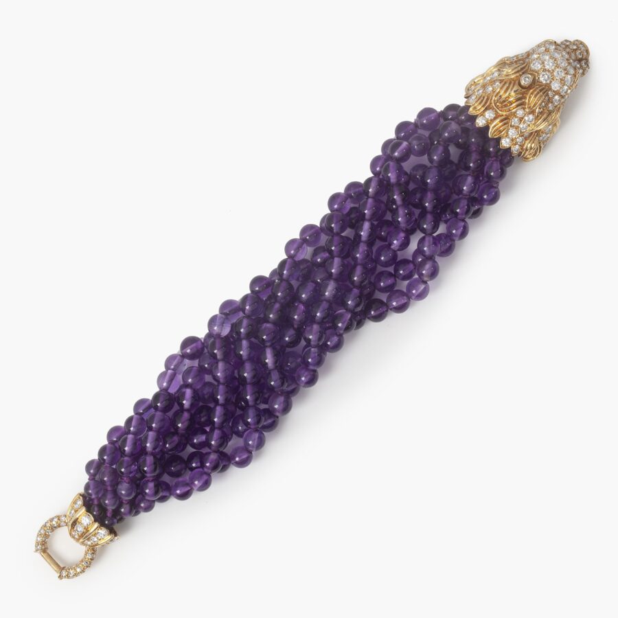 A yellow gold bracelet ‘Lion Barquerolles’ designed as a lion’s head clasp on amethyst beads. Signed Van Cleef & Arpels, New York. Numbered and dated 1971.