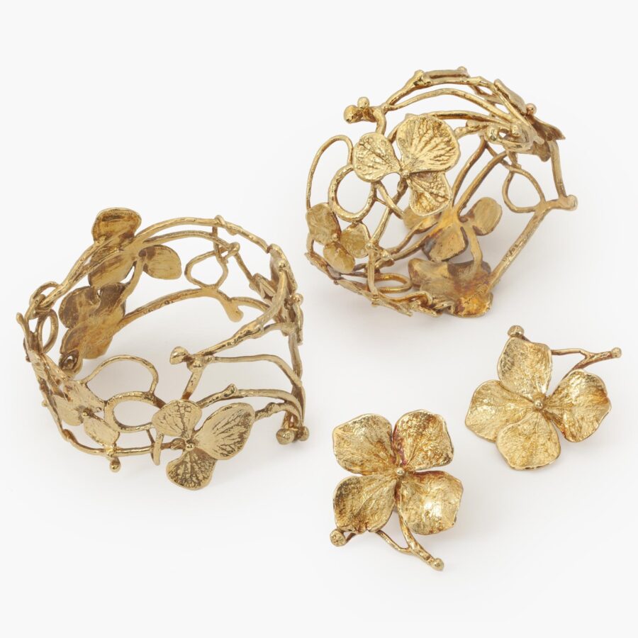 A pair of eighteen carat yellow gold bangles ‘Entrelacs’, each with seven hydrangea flowers, signed Claude Lalanne, made in Paris, ca 1980-90.