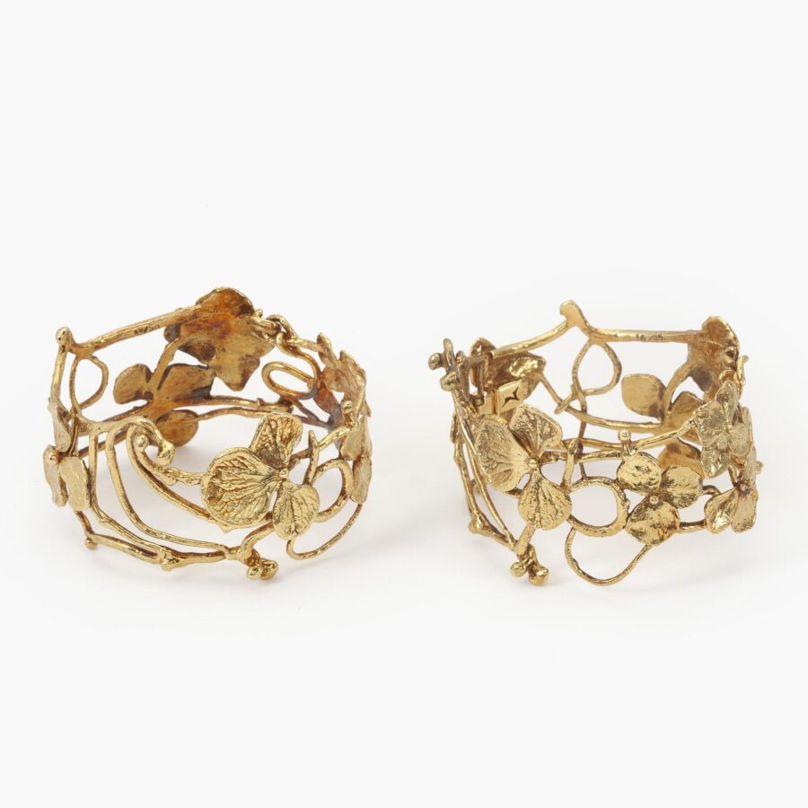 A pair of eighteen carat yellow gold bangles ‘Entrelacs’, each with seven hydrangea flowers, signed Claude Lalanne, made in Paris, ca 1980-90.