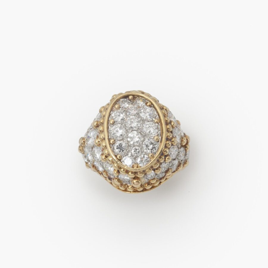 An eighteen carat yellow gold and platinum ring, pavé set with brilliant cut diamonds and with numerous spheres. Van Cleef & Arpels, Paris, ca 1970.