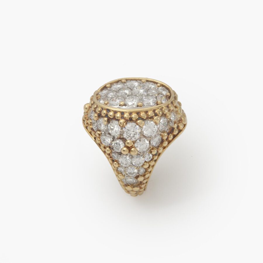 An eighteen carat yellow gold and platinum ring, pavé set with brilliant cut diamonds and with numerous spheres. Van Cleef & Arpels, Paris, ca 1970.