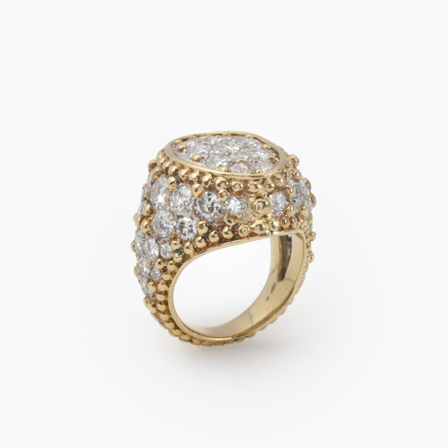 An eighteen carat yellow gold and platinum ring, pavé set with brilliant cut diamonds and with numerous spheres. Van Cleef & Arpels, Paris, ca 1970.