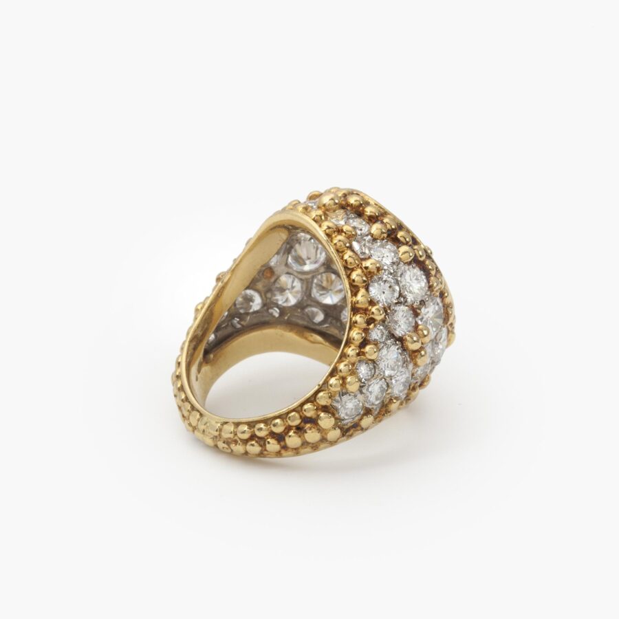 An eighteen carat yellow gold and platinum ring, pavé set with brilliant cut diamonds and with numerous spheres. Van Cleef & Arpels, Paris, ca 1970.