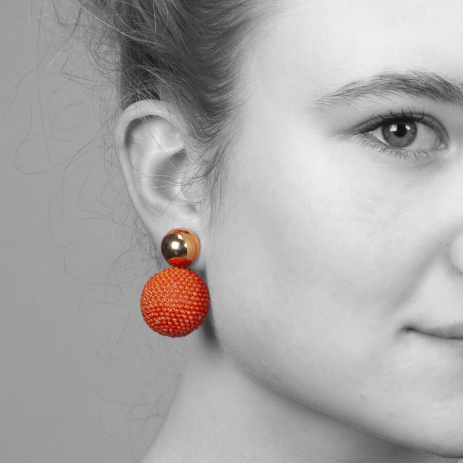 A pair of eighteen carat yellow gold clip earrings, designed as a sphere decorated with coral beads. Signed Hemmerle, Munich.