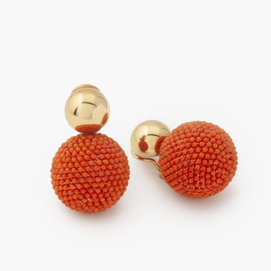 A pair of eighteen carat yellow gold clip earrings, designed as a sphere decorated with coral beads. Signed Hemmerle, Munich.