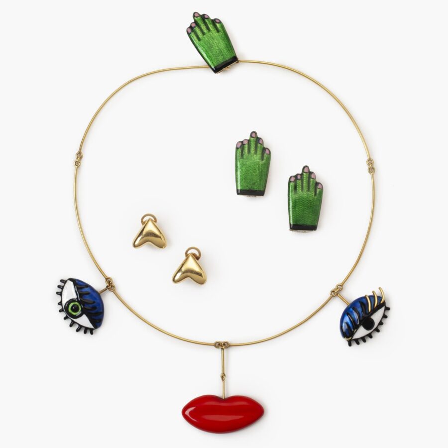 An eighteen carat yellow gold necklace with three pendants forming a face, with two pairs of matching earrings. Signed Niki de Saint Phalle, dated 1973.