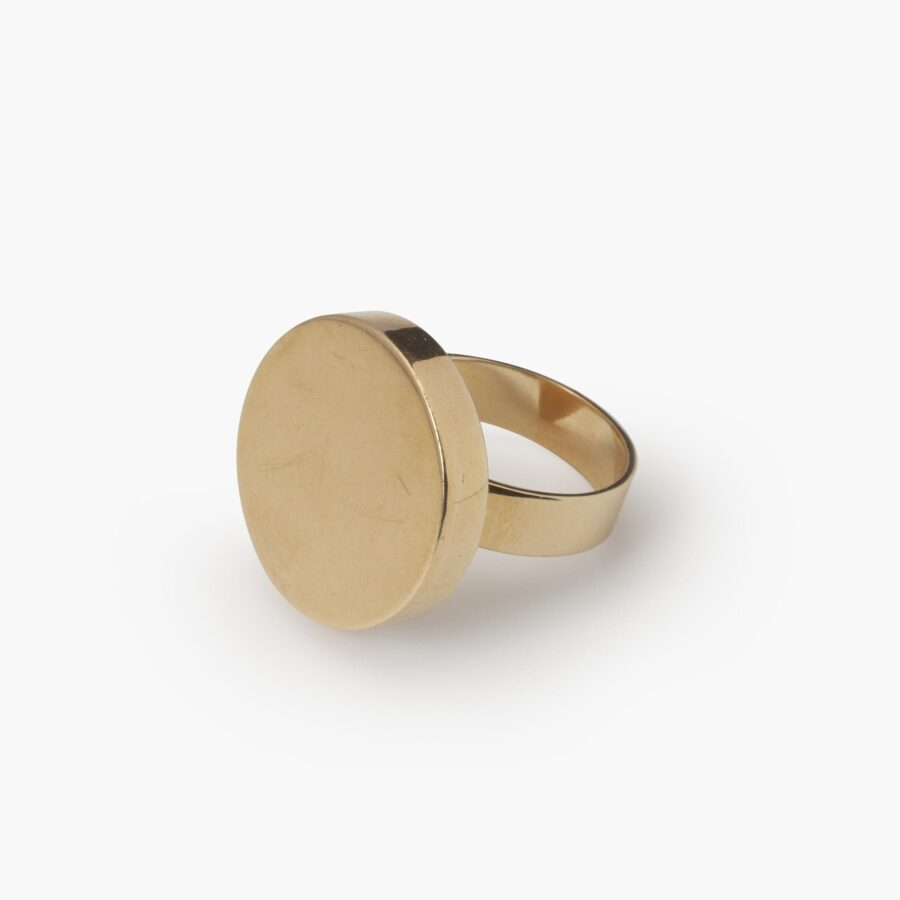 An eighteen carat yellow gold ring designed as a disc on a plain shank. Signed Jean Dinh Van for Cartier, made in New York, ca 1970 and numbered.