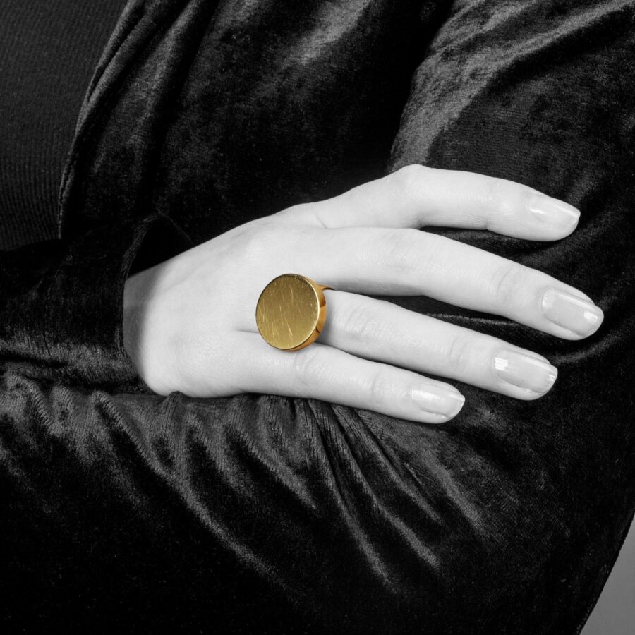 An eighteen carat yellow gold ring designed as a disc on a plain shank. Signed Jean Dinh Van for Cartier, made in New York, ca 1970 and numbered.