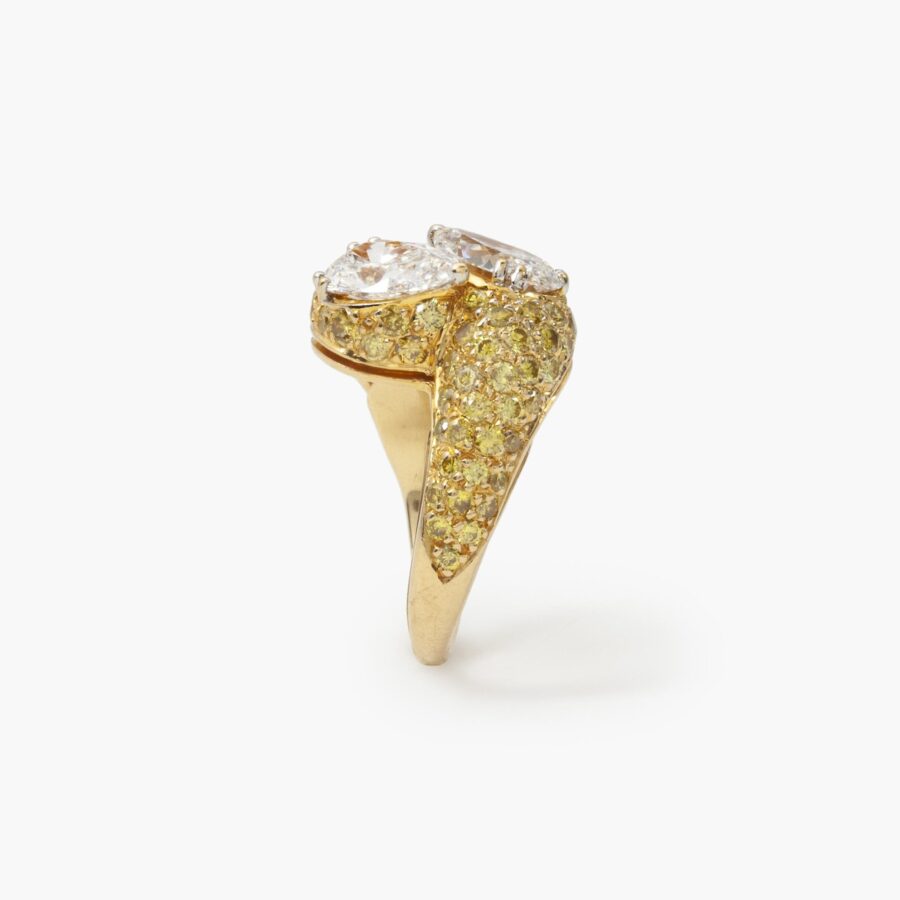 An eighteen carat yellow gold cross over ring ‘Toi et Moi’ set with two pear shaped diamonds and  many yellow diamonds. Made by Graff and numbered.