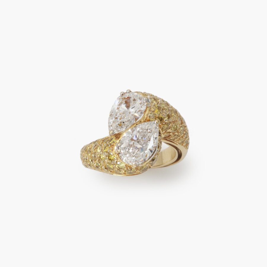 An eighteen carat yellow gold cross over ring ‘Toi et Moi’ set with two pear shaped diamonds and  many yellow diamonds. Made by Graff and numbered.