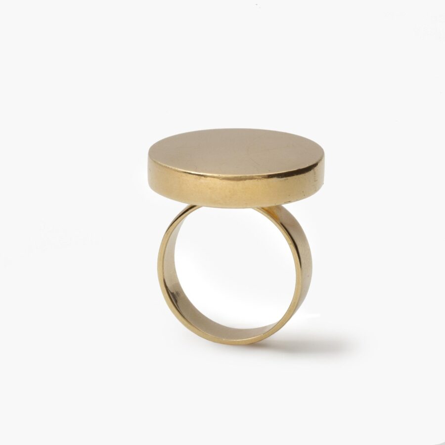 An eighteen carat yellow gold ring designed as a disc on a plain shank. Signed Jean Dinh Van for Cartier, made in New York, ca 1970 and numbered.