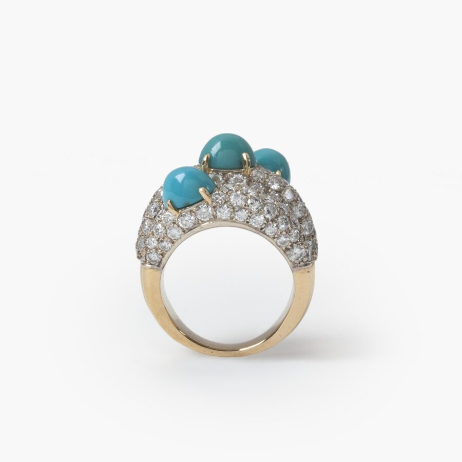 An eighteen carat yellow gold and platinum ring of triple bombé design, set with diamonds and turquoise. Signed Cartier Paris, made ca 1960.