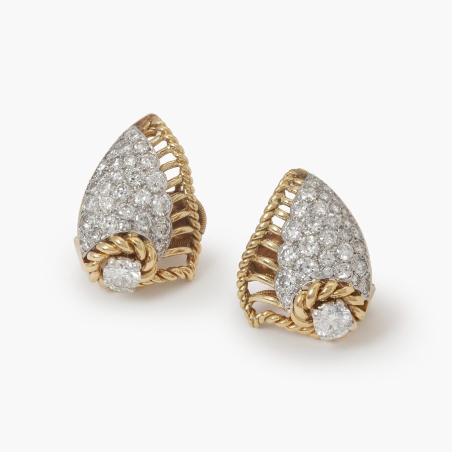 A pair of eighteen carat yellow gold and platinum diamond set clip earrings, each designed as a shell. Signed Cartier Paris, made ca 1950 and numbered.