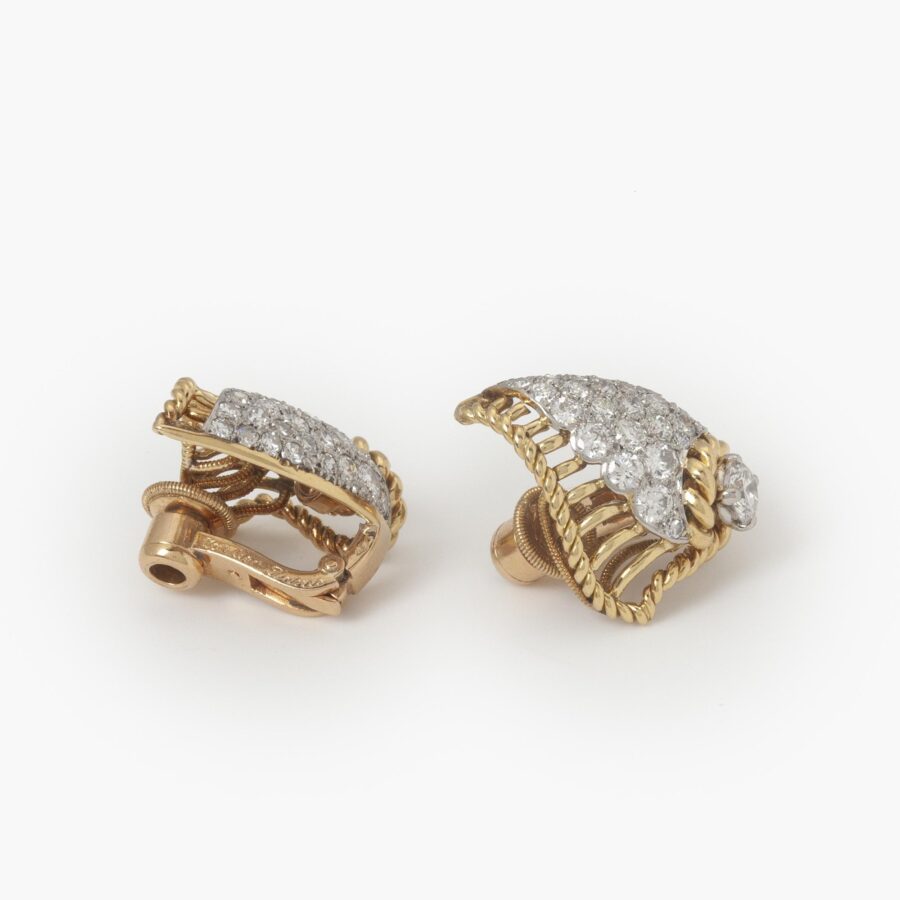 A pair of eighteen carat yellow gold and platinum diamond set clip earrings, each designed as a shell. Signed Cartier Paris, made ca 1950 and numbered.