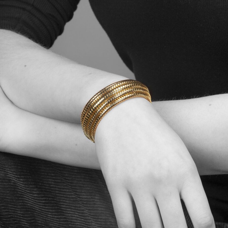 An eighteen carat yellow gold ‘Tubogaz’ cuff bracelet constructed by five rows, the bracelet closes by tension. Signed Bvlgari, made in Italy.