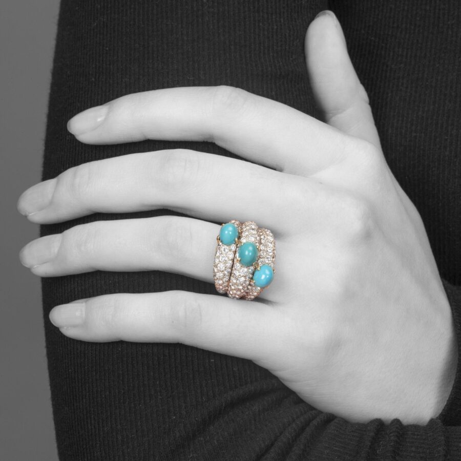 An eighteen carat yellow gold and platinum ring of triple bombé design, set with diamonds and turquoise. Signed Cartier Paris, made ca 1960.