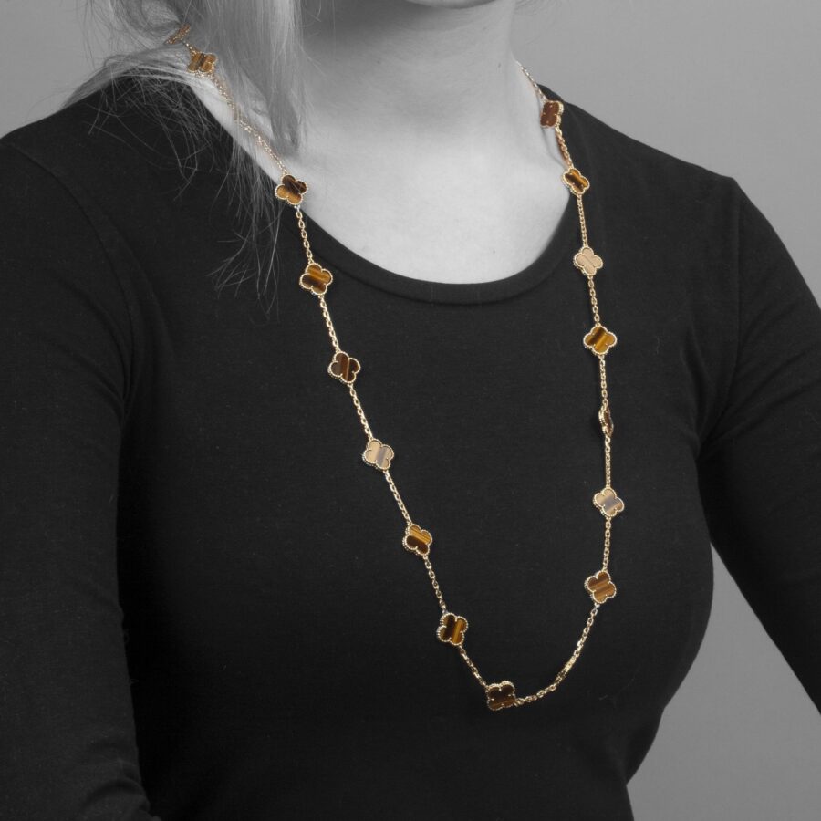 An eighteen carat yellow gold extra long “Alhambra” longchain of twentythree tiger’s eye “Alhambra” motifs. Signed Van Cleef & Arpels. Dated 1971. 