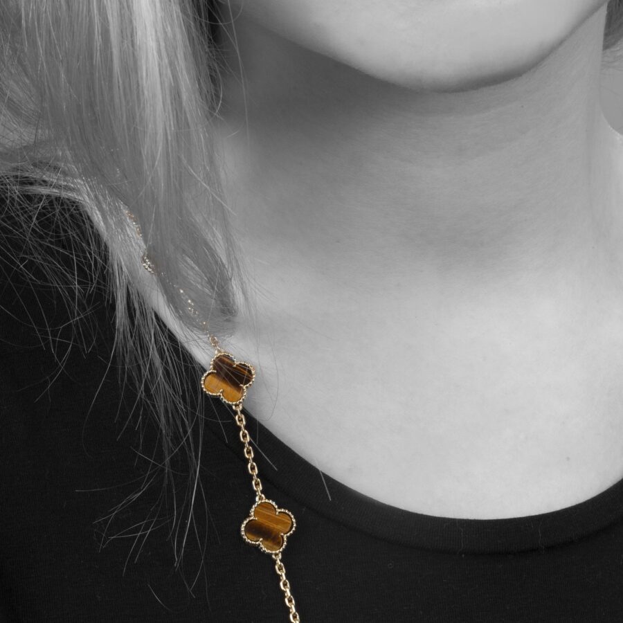 An eighteen carat yellow gold extra long “Alhambra” longchain of twentythree tiger’s eye “Alhambra” motifs. Signed Van Cleef & Arpels. Dated 1971. 