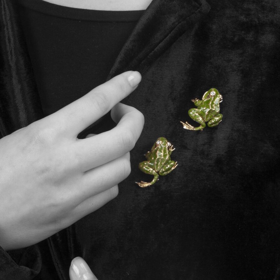 A pair of eighteen carat yellow gold brooches, each designed as a frog, with green enamel and diamond eyes. Signed Van Cleef & Arpels, Paris, 1966.