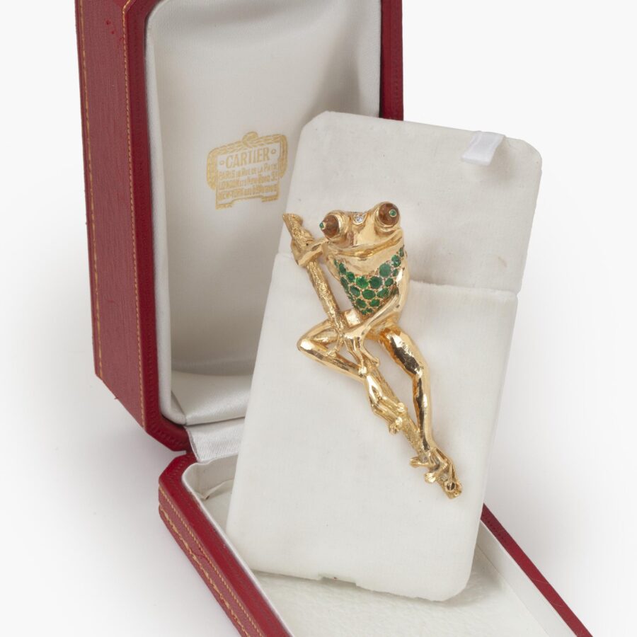 An eighteen carat yellow gold brooch designed as a frog on a branch, set with emerald, diamond and citrine. Signed Cartier Paris, made ca 1980.