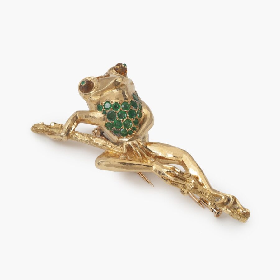 An eighteen carat yellow gold brooch designed as a frog on a branch, set with emerald, diamond and citrine. Signed Cartier Paris, made ca 1980.